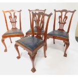 A set of four Edwardian Chippendale style mahogany single dining chairs, with leaf carved crest rail