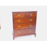 A George III mahogany straight fronted chest, of two short over three long graduated drawers, raised