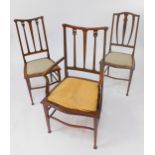 An Edwardian mahogany and line inlaid carver chair, and a pair of matched single chairs. (3)