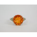 A silver Padparadscha quartz and white topaz ring, high claw set, quartz 6.22ct, size N/O, with