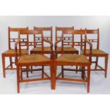 A set of six George III elm and rush seated country dining chairs, comprising pair of carvers and