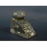 A Victorian cut glass inkwell, of stepped rectangular form, with an hinged glass lid, 8.5cm deep.