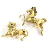 Two metal animal figures, comprising one of a horse, the other a lion, each with gold coloured