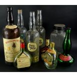 A collection of whisky and other bottles, to include a large bottle of Mackinlay's three bottles