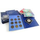 A quantity of coins, to include coin sets, a small album containing coins, etc.