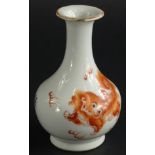 A Chinese porcelain bottle shaped vase, with trumpet stem, decorated with dragons in orange, on a