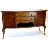 An early 20thC mahogany bow fronted sideboard, the top with a moulded edge above two frieze