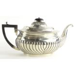 An Edwardian silver teapot, with part fluted decoration, ebonised knop and handle, Birmingham