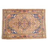 A Persian type rug, with a central red lozenge decorated with geometric devices, navy blue