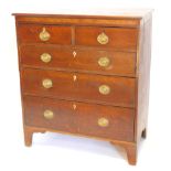 An early 19thC oak and mahogany chest of drawers, the top with a moulded edge above two short and