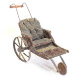 A late 19thC child's miniature sedan type chair, with padded back and seat, two large spoked