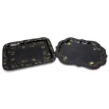 Two Victorian ebonised papier mache trays, one decorated in gilt with flowers, 76cm wide, the