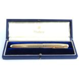 A Parker 51 9ct gold fountain pen, with engine turned decoration, stamped 9, 0.375, in blue