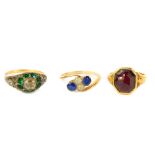 Three gem set dress rings, including sapphire and white stone example, all set in yellow metal.