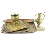 Various Indian brass and copper trays, each with elaborate decoration, an embossed and repousse