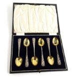 A set of six Chinese white metal teaspoons, each with a dragon cast to handle and a gilt bowl, in