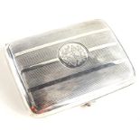 An Edwardian silver cigarette case, with engine turned decoration and central monogram, Birmingham
