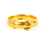 A yellow metal buckle ring, marked 18ct, 4.8g.