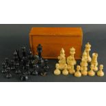 A small sycamore and ebonised chess set, unmarked and boxed.