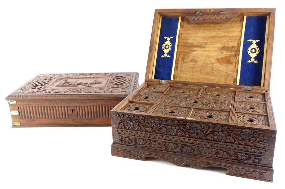 A heavily carved travelling stationery box, possibly Burmese, of rectangular form, with an oval