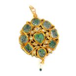 An Indian circular pendant, set with green and yellow stones and having a pearl drop, decorated