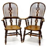 A pair of 19thC and elm Windsor chairs, each with a high back and a Christmas tree type pierced