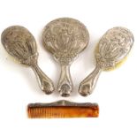 An early 20thC associated silver mounted dressing table set, each piece with a design of an Art