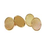 A pair of 9ct gold oval cufflinks, with engine turned decoration, 12.7g.