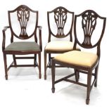 Three mahogany dining chairs in George III style, to include a carver chair, each with a padded seat