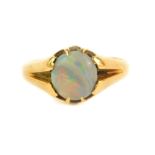 An 18ct gold dress ring, set with a single opal, Birmingham assay, 3.7g all in.