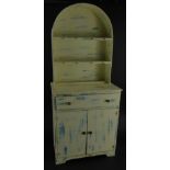 A miniature child's Dutch style dresser, with arched plate rack, frieze drawer and two cupboard