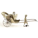 An eastern silver plated cruet, modelled in the form of a rickshaw, with spoked wheels, containing a