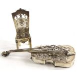 A continental white metal pill box, modelled in the form of a violin or cello, with embossed and