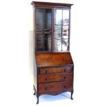A 1920s/1930s walnut bureau bookcase, the top with a moulded cornice with two astragal glazed