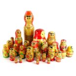 A collection of mid to late 20thC Russian dolls, various sizes and decoration, the largest 33cm