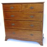 An Edwardian mahogany and rosewood crossbanded chest of drawers, the top with a moulded edge,