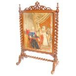 A Victorian rosewood firescreen, with a pierced crest above a wool work panel depicting King Charles