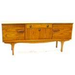 A 1960s/1970s teak concave shaped sideboard, with single frieze drawer above a fall front door