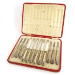 A set of six George V silver handled dessert knives and forks, with silver plated blades,