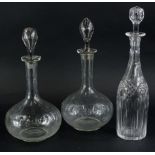 A pair of cut glass decanters and stopper, and a similar decanter.