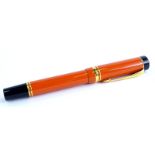 A Parker red and black two tone Duofold fountain pen, with gold plated mounts, the nib stamped 18K