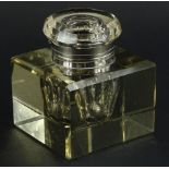 A large square Edwardian faceted glass inkwell, with silver plated mounts, 10cm wide.