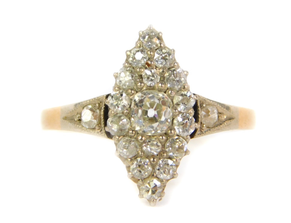 An 18ct gold diamond marquise cluster ring, set with old cut stones to the shoulders and mount, 3.1g