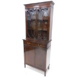 An Edwardian mahogany and ebony strung bookcase, the top with a moulded and inlaid dentil cornice,