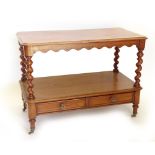 A Victorian mahogany two tier buffet, the top with a moulded edge on spirally turned supports,