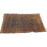 A Turkomen type rug, with an all over design of brown and orange medallions, on a navy ground with