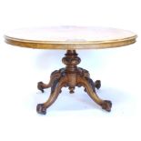 A Victorian burr walnut oval breakfast table, the top with a moulded edge on a part turned leg