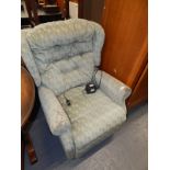 A Celebrity electric reclining chair in green diamond pattern material, 102cm high.