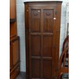 An oak hall wardrobe, with single linen fold carved door.