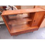 A 1960's/70's teak side cabinet with two sliding doors, with cupboard door above two drawers, on